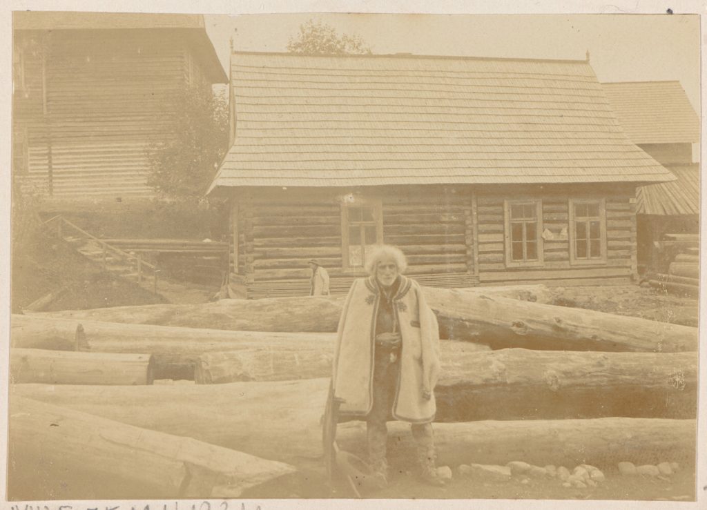 Zakopane, Krupówki, stary góral na tle chałupy
